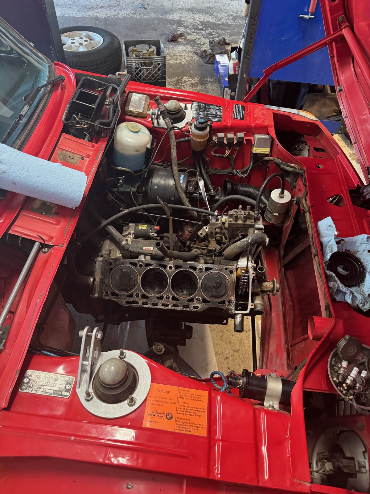 BMW 2002 engine bay during rebuild — head removed, bare block exposed