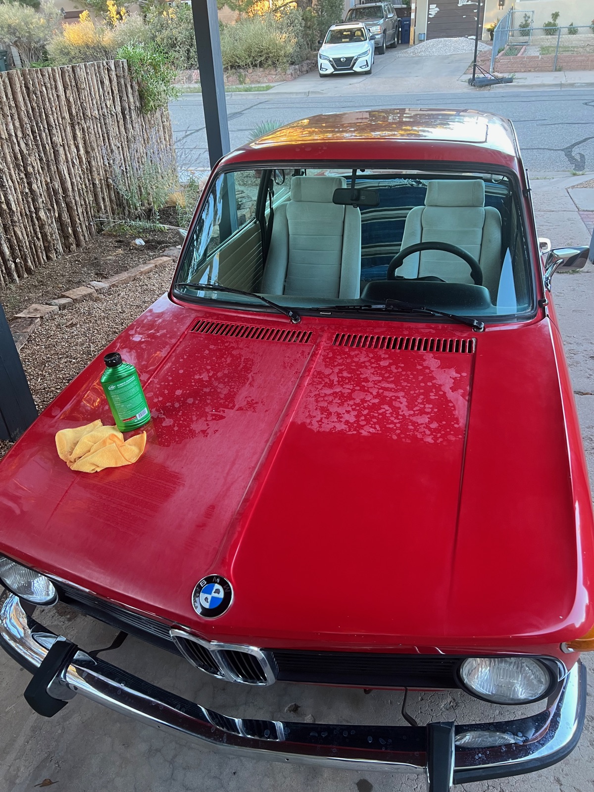 BMW 2002 hood mid-polish with cleaning supplies