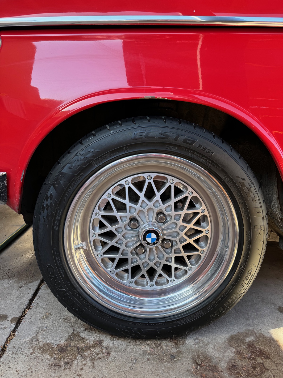 BMW 2002 wheel and fender detail — BBS mesh wheels on Verona Red